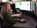 Call attendant at work at E-Comm's main dispatch center in Vancouver.  E-Comm staff are the first point of contact for 911 dialers, routing calls to the appropriate police, fire and ambulance dispatchers.