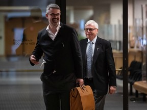 Craig James, back right, former clerk of the B.C. legislative assembly, leaves B.C. Supreme Court with his lawyer after being sentenced in Vancouver, on Friday, July 8, 2022. A B.C. Supreme Court Judge has handed the former clerk of British Columbia's legislature a conditional sentence to be served under house arrest for three months.