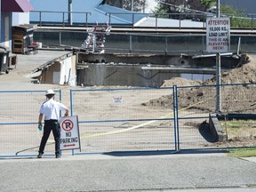 Emergency services were called to the collapsed parking lot roof at a store on E. Broadway near Rupert Street in Vancouver, BC on Thursday, July 14, 2022.
