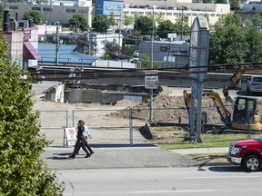 Emergency services were called to the collapsed parking lot roof at a store on E. Broadway near Rupert Street in Vancouver, BC on Thursday, July 14, 2022.