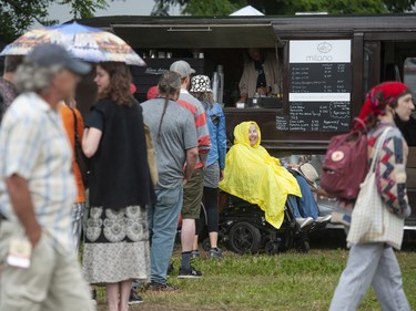 Spirits were not dampened by looming rain clouds at Jericho Beach in Vancouver, BC Saturday, July 16, 2022 as crowds of people took part in the 45th annual Vancouver Folk Festival.  Musicians, vendors and food trucks entertained the crowds at the family-friendly event.