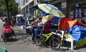 Tents line sidewalks of East Hastings Street in Vancouver on Tuesday.