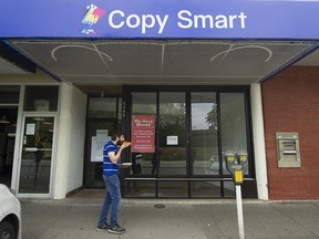 A man walks past a store where a cannabis retail store was recently approved on University Endowment Lands near UBC.