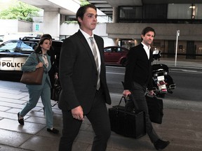 Former Vancouver Canucks winger Jake Virtanen arrives for the trial on Tuesday with his lawyer, Brock Martland.