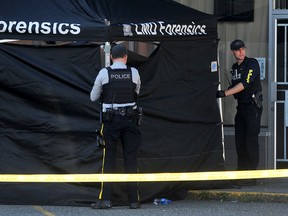 Police set up a tent in the parking lot next to the Mission Thrift Shop on Logan Ave. and Glover Road.