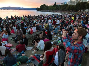 Tens of thousands of people fill the beach at English Bay in Vancouver during fireworks night.