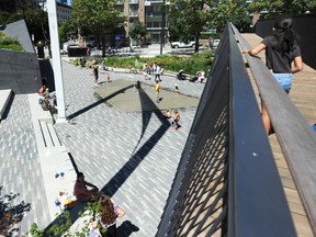 Sun lovers enjoy the hot weather at Rainbow Park in downtown Vancouver.