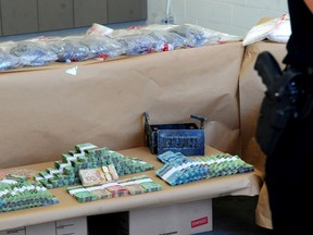 Contraband on display as Vancouver Police Insp. Phil Heard comments on an investigation that resulted in $8 million in drugs and over $170,000 in cash seized.