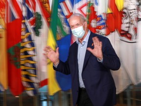 Prime Minister John Horgan gestures during a break from Canada's prime ministers' summer meeting in Victoria on Monday.