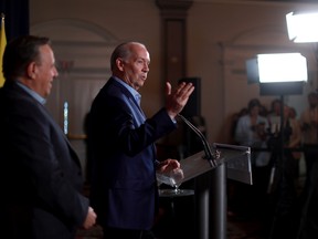 Quebec Premier Francois Legault (left) and B.C. Premier John Horgan answer questions during a press conference on the second day of the summer meeting of the Canada's Premiers in Victoria, B.C., on Tuesday, July 12, 2022