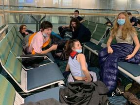 William Isabel (pink shirt), Laurence L'Homme and Amelie Tremblay, traveling with their scouting party from Quebec, spent Saturday night sleeping at YVR gate B26 after their connecting flight to Whitehorse was delayed and cancelled. , and then it will be canceled again for the next few days.  .  They are part of a group of 20 teenagers and their group leaders who have spent the last three years planning a week-long trip to the Yukon.