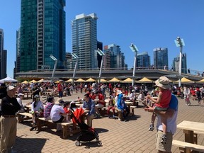 People gathering at Jack Poole Plaza for Canada Day festivities at Canada Place.