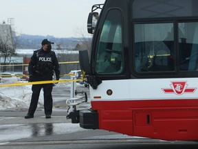 File photo: A police officer stands by a TTC bus.