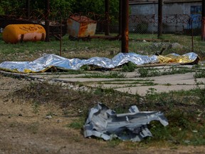 Bodies of detainees lie covered by tarps following the shelling at a pre-trial detention centre in the course of Ukraine-Russia conflict, in the settlement of Olenivka in the Donetsk Region, Ukraine, on July 29, 2022.