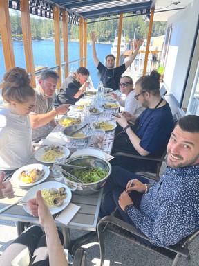 Chef Anthony Santi waves from the head of a table on Upper Deck’s patio.