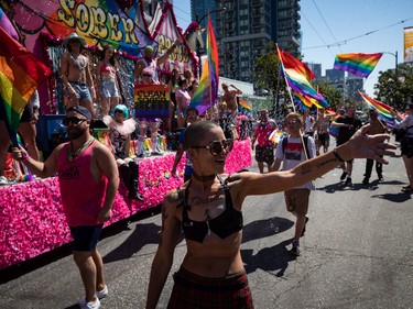 Bubbles fill the air as people stand on a float while others march along side during the Vancouver Pride Parade, in Vancouver, on Sunday, July 31, 2022. THE CANADIAN PRESS/Darryl Dyck