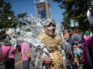 Kevin Young smiles while putting on a costume before marching in the Vancouver Pride Parade, in Vancouver, on Sunday, July 31, 2022.