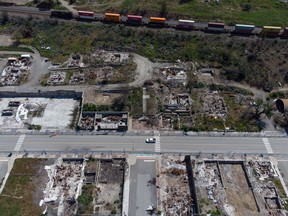 A freight train travels past the remains of houses and businesses destroyed by the 2021 wildfire, in Lytton, B.C., on Wednesday, June 15, 2022. The acting chief of the Lytton First Nation says about 30 evacuees briefly returned home in an effort to salvage food they left behind in freezers when a wildfire broke out Thursday nearly two kilometres northwest of Lytton.&nbsp;CANADIAN PRESS/Darryl Dyck