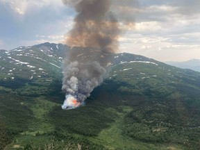 The Cap Mountain fire burning near Whitehorse, Yukon is shown on Tuesday July 5, 2022. Wildfires are breaking out across Yukon as lightning pummels the territory and a heat wave wears on, a fire information officer says.