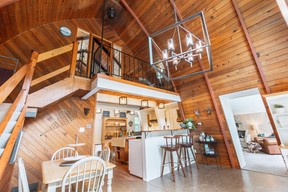 Curved, wood-clad walls surround the first-level bedroom, kitchen and dining area.