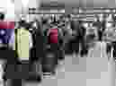 People line up before entering the security at Pearson International Airport in Toronto on Friday, August 5, 2022.