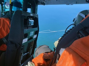 Absorbent barrier in the water to absorb oil.  Image from a US Coast Guard helicopter of the oil slick from a sunken fishing boat on August 14, 2022.
