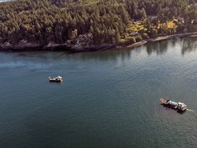 Salvage and clean-up vessels on the scene. Photo taken from a U.S. Coast Guard helicopter on Aug. 14, 2022.
