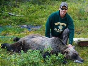 Clayton Lamb, a post-doctoral student at UBCO shown here with a tranquilized bear, has lobbied for a later start to the trapping season in southeast B.C. after discovering seven per cent of the grizzly bears they studied had toes chopped off by marten traps.