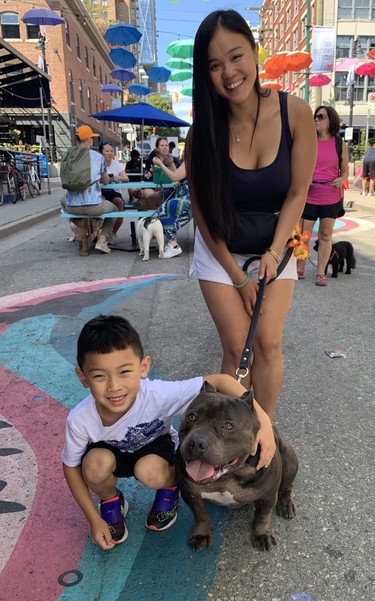 Pauline Huynh with nephew Andre Nguyen and American Pocket Pit Bull Kilo at the Just Love Animal Society's Pet-A-Palooze in Vancouver's Yaletown on Sunday, Aug. 28, 2022. Photo: Denise Ryan. For Denise Ryan's piece slugged 0829 petapalooza. [PNG Merlin Archive]