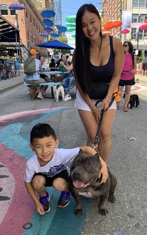 Pauline Huynh with nephew Andre Nguyen and American Pocket Pit Bull Kilo at the Just Love Animal Society’s Pet-A-Palooze in Vancouver’s Yaletown on Sunday, Aug. 28, 2022.