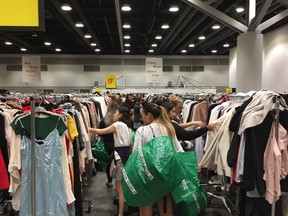 Shoppers search the racks at the annual Aritzia Warehouse Sale at the Vancouver Convention Centre West on Aug. 27, 2019.