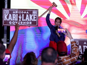 Republican candidate for Arizona Governor Kari Lake holds up a sledgehammer as she speaks to supporters that are waiting around as ballots continue to be counted during her primary election night gathering at the Double Tree Hotel on August 03, 2022 in Scottsdale, Arizona.