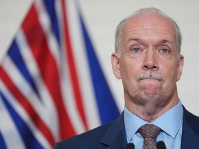 B.C. Premier John Horgan pauses during a news conference in Vancouver, on June 28, 2022. Premier John Horgan has called a byelection for the Surrey South electoral district.