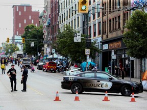 Vancouver police block a roadway as unhoused people begin removing their belongings and tent structures after the fire department issued an order to clear the camp because of fire safety concerns, at a homeless camp along the city’s East Hastings Street in Vancouver, British Columbia, Canada August 9, 2022.