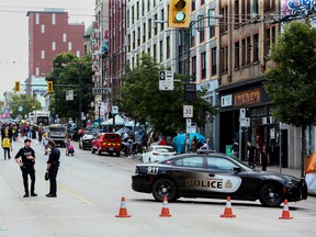 Vancouver police block a road as homeless people begin to remove their belongings and tent structures after the fire department issued an order to clear the camp due to fire safety concerns, at a camp for people homeless along the city's East Hastings Street in Vancouver, British Columbia, Canada August 9, 2022.