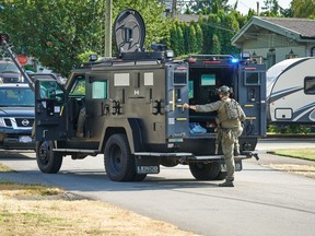 A police raid is conducted at a residence in Abbotsford, British Columbia, where officers say they found a methamphetamine lab, 3kg of opioids and 7.4kg of methamphetamine on Aug. 23, 2022. The raid involved Abbotsford Police, RCMP and other officers.