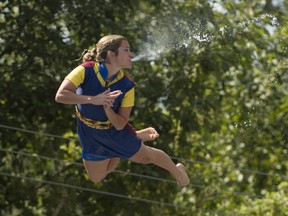 Entertainers participate in the Flying Fools High Diving Show at the Pacific National Exhibition on Saturday, Aug. 20, 2022.