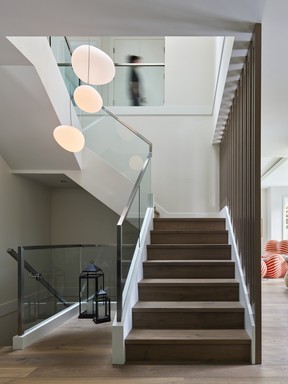 Circular lighting juxtaposed by the hard angles of the joinery incorporated into the stair fixture create an avant-garde effect.