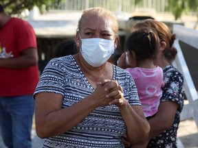 A relative reacts as she waits for news about her loved ones outside the facilities of a coal mine, where a mine shaft collapsed leaving miners trapped, in Sabinas, Coahuila state, Mexico, August 6, 2022. REUTERS/Luis Cortes
