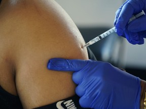 Pfizer booster shot from a nurse at a vaccination site Tuesday, Feb. 8, 2022.