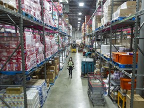 Donated food to be distributed at the Greater Vancouver Food bank in Burnaby. Columnist Vaughn Palmer says there has been little sign of action on the B.C. premier's promise of measures to reduce the effect of inflation.