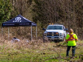 RCMP officers collecting evidence at the scene of a suspicious death on Wednesday, March 30, 2022 in a vacant lot in Langley.
