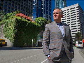 Jon Stovell of Reliance Properties stands near a parking garage at the corner of Melville and Thurlow Streets in downtown Vancouver, BC Wednesday, April 14, 2021.