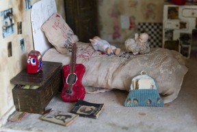 The Beatles fan's bed has a toy Beatles guitar propped up against it, along with a bedspread full of Beatles letters.