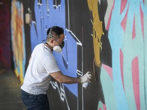 Graffiti artist Tars works on a creation at the Holden Courage Graffiti Jam as part of the Vancouver Mural Festival in Vancouver on Saturday.