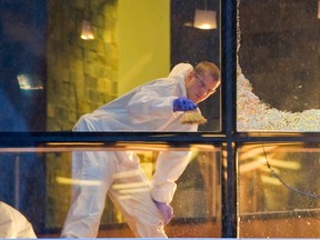 Workers clean the scene of a shooting at Vancouver Wall Centre restaurant on Jan. 18, 2012.