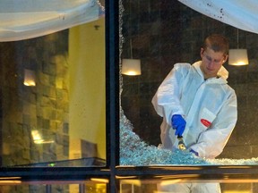 Workers clean the area around the scene of the shooting of Sandip Duhre at Vancouver's Wall Centre restaurant in January 2012.