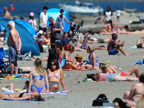 Sun lovers enjoy the hot weather at Kits Beach in Vancouver in a recent file photo.