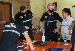 Members of the Child Protection Unit, a joint venture between the Cambodian Children’s Fund and the Cambodian National Police assess evidence in the case of a Vancouver man, Andrew David Eyre, accused of sexually assaulting several Cambodian children.