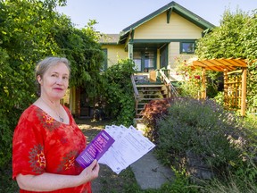 Helen Ward shows off some of the paperwork after she was billed $27,000 in speculation tax by the B.C. government because she had yet to file her income tax return.